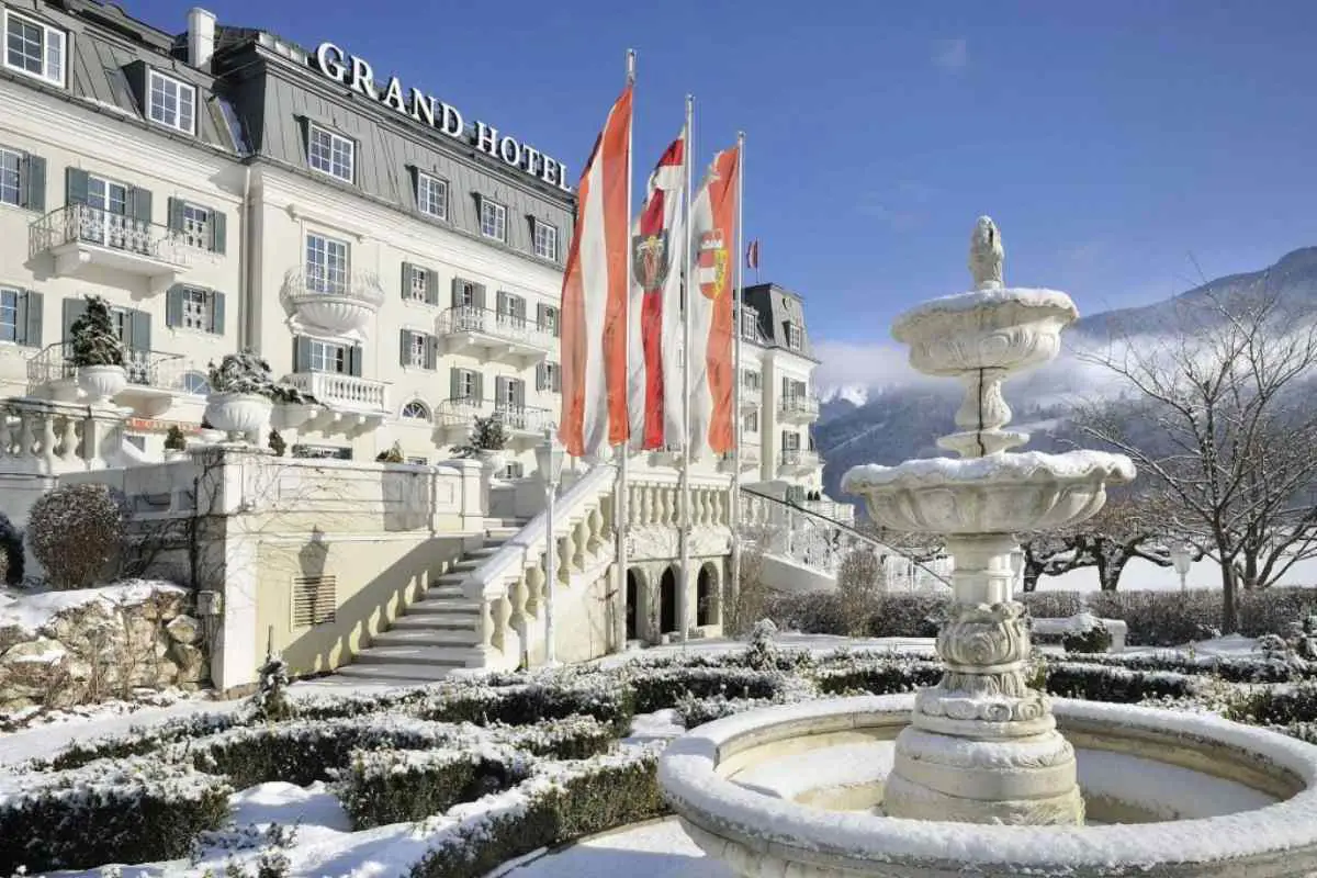 The Grand Hotel Zell Am See in Austria covered in a light dusting of snow on a clear day