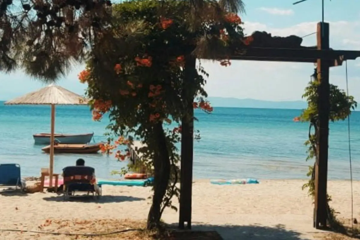The golden sands against blue waters at Thasos in Greece. Photo by  Reiseuhu on Unsplash