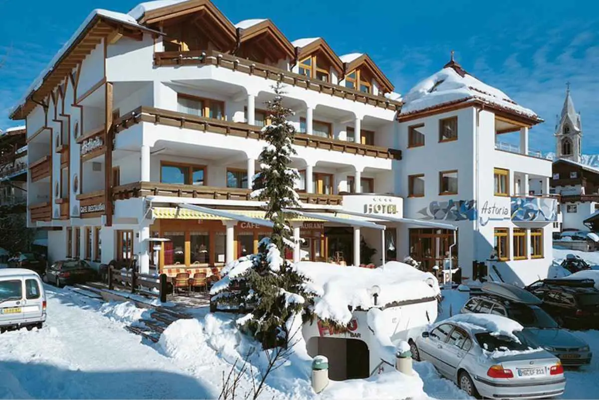 Hotel Astoria in the Serfaus-Fiss-Ladis ski resort in Austria, surrounded by snow on a clear blue sky day
