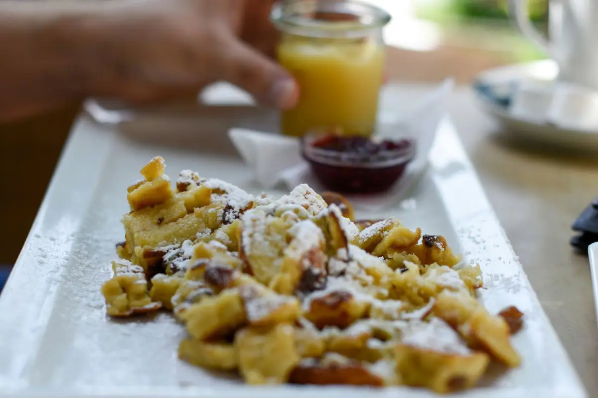 Close up of traditional Austrian dessert Kaiserschmarren which consists of a fluffy pancake shredded and served with a fruit compote. Photo by Daria S from Unsplash