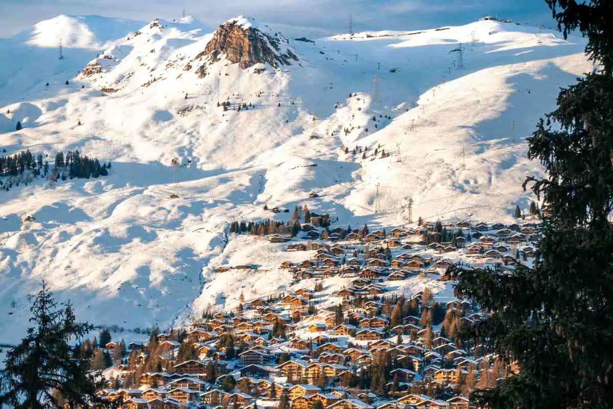 The Snow Capped Mountains Stand Tall Above The Wooden Chalets In The Vallery Of Verbier, Switzerland. Photo By Sebastian Staines, Unsplash