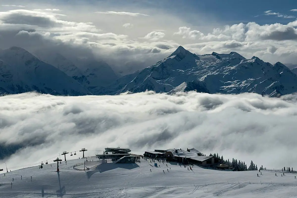 Clouds form over the snow capped peaks of the Kaprun ski resort in Austria. Photo by Lewis Teale from Unsplash